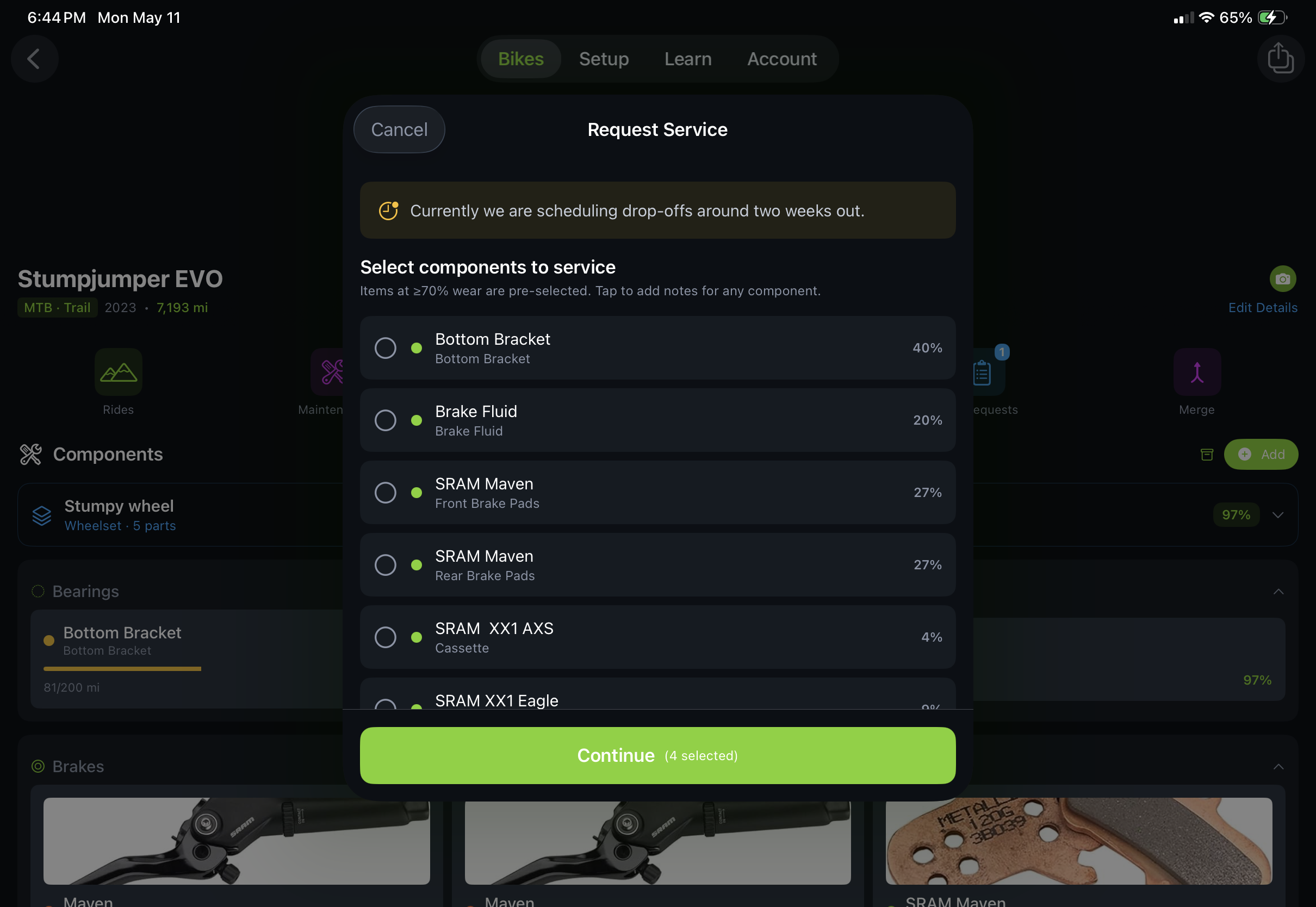 Trail Hits consumer app, Request Service flow on iPad showing components pre-selected for service and the shop's note 'Currently we are scheduling drop-offs around two weeks out'
